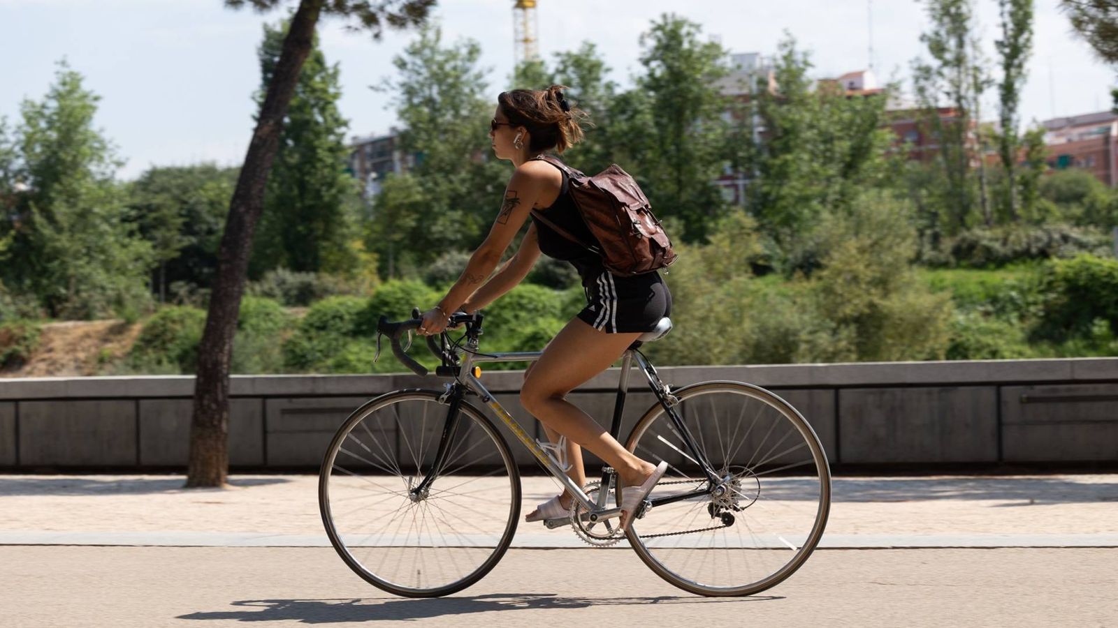 Una persona monta en bicicleta en un parque de Madrid