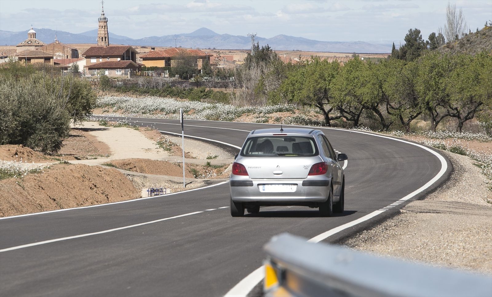 Un vehículo afronta una curva en una carretera convencional