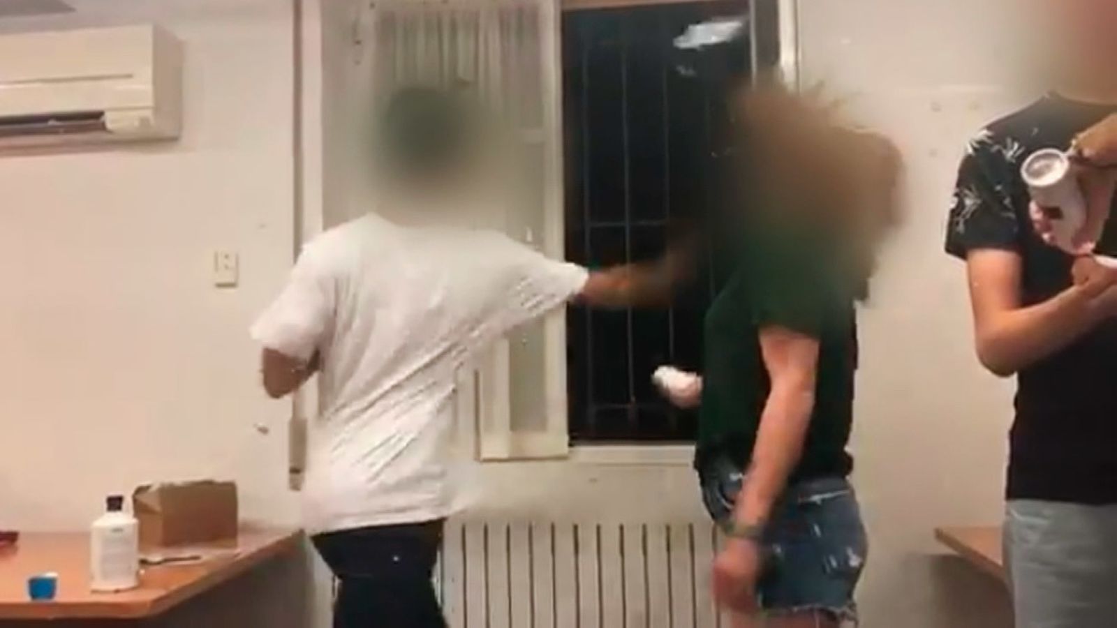 Imagen captada de un video en el que un estudiante le da una bofetada a una compañera durante una novatada