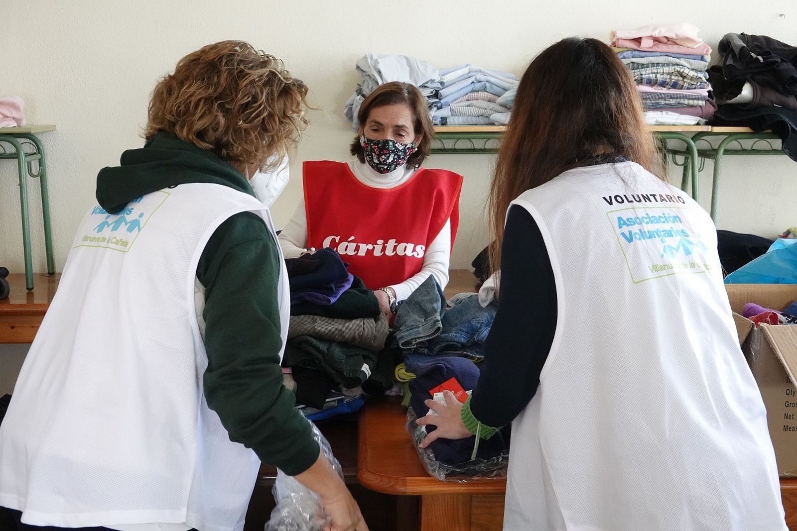 Voluntarias clasifican ropa en Villanueva de la Cañada para enviarla a la frontera de Rumania y Ucrania