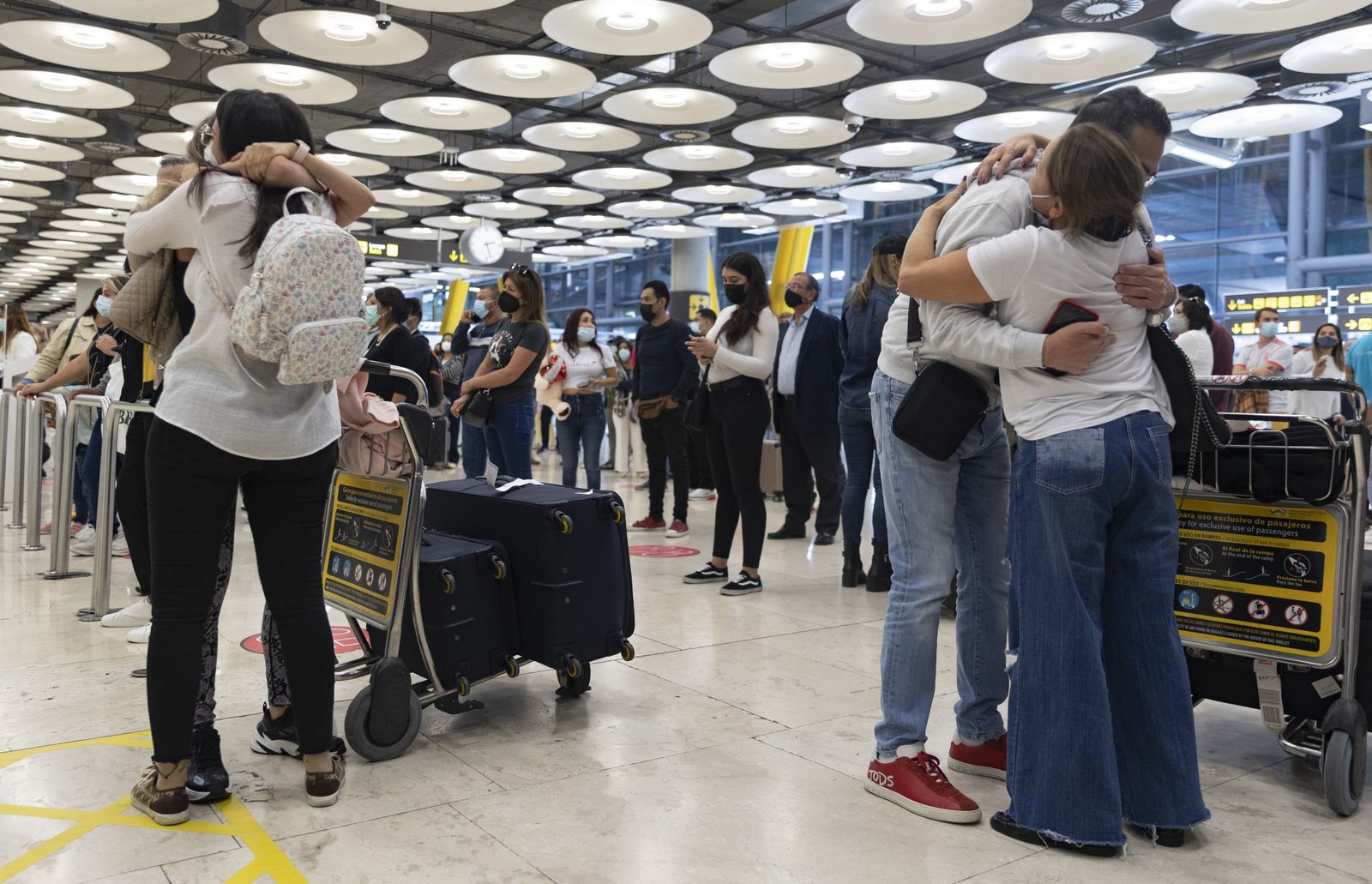 Varias personas se abrazan en el aeropuerto de Madrid Barajas