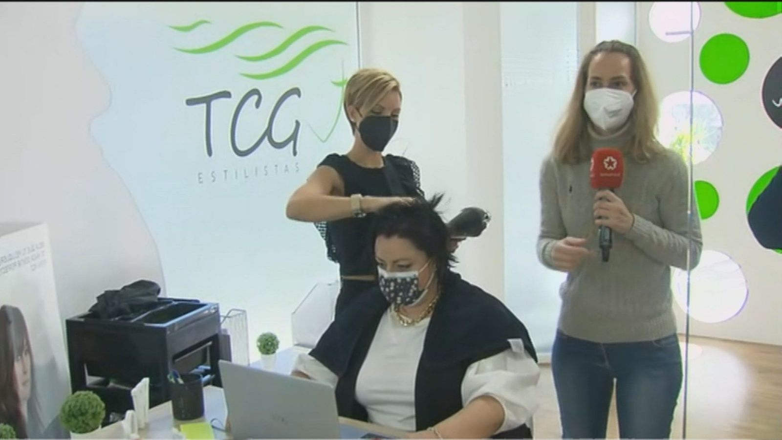 Teletrabajar desde la 'pelu': Cortan, tiñen y peinan mientras las clientas trabajan con su ordenador