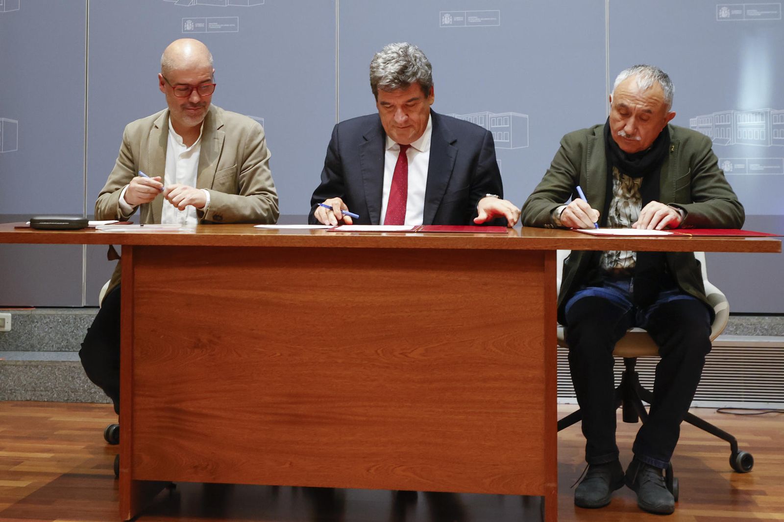 El ministro de Inclusión y Seguridad Social, José Luis Escrivá (c), y los secretario generales de CCOO y UGT, Unai Sordo (i) y Pepe Álvarez (d), durante la firma del acuerdo para la última parte de la reforma de las pensiones