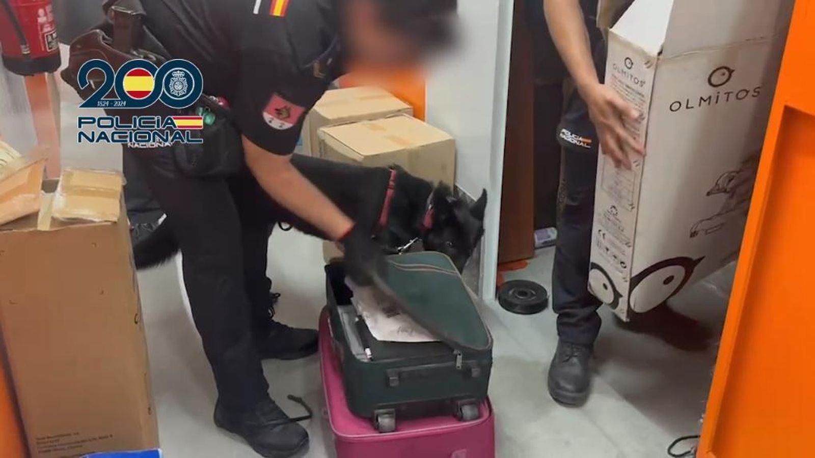 Un agente de la Policía Nacional investiga una maleta