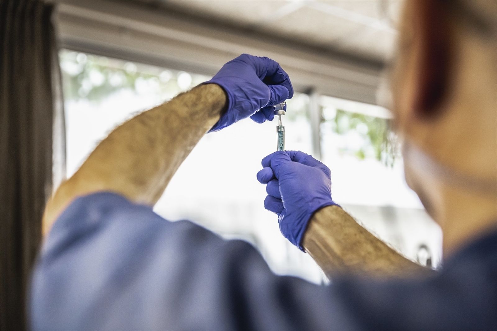 Sanitario sosteniendo una vacuna