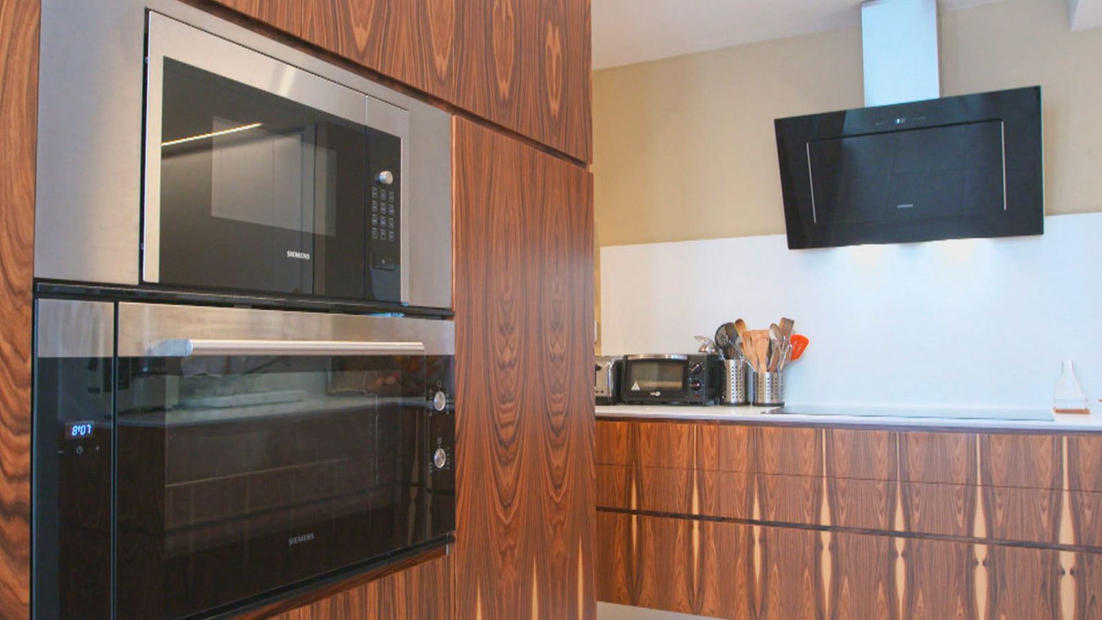 Aunque ene sta casa encontramos muchos otros lugares maravillosos y originales, como este, la cocina, con los muebles en madera  de palisandro, con estas preciosas vetas decorativas.