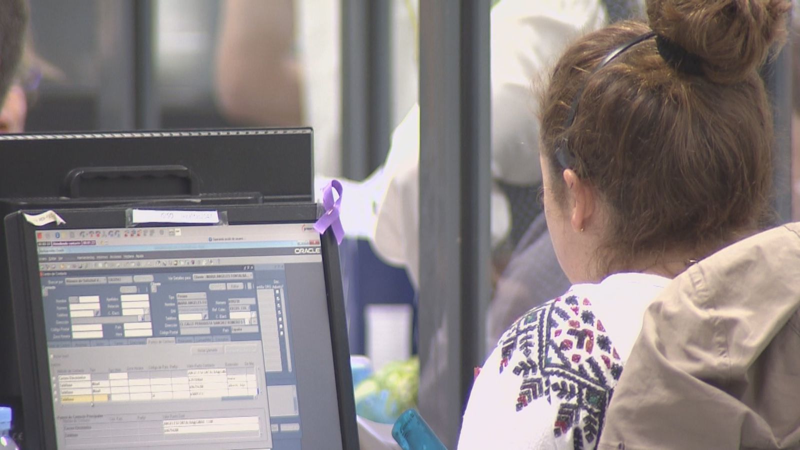Una mujer ante un ordenador en su puesto de trabajo