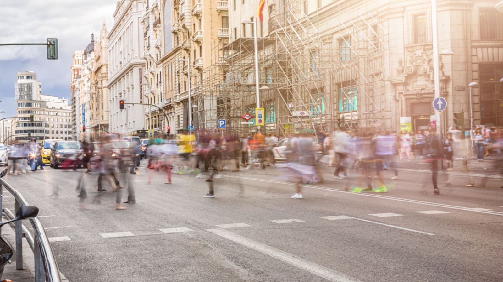 Un amplio grupo de peatones cruza la Gran Vía