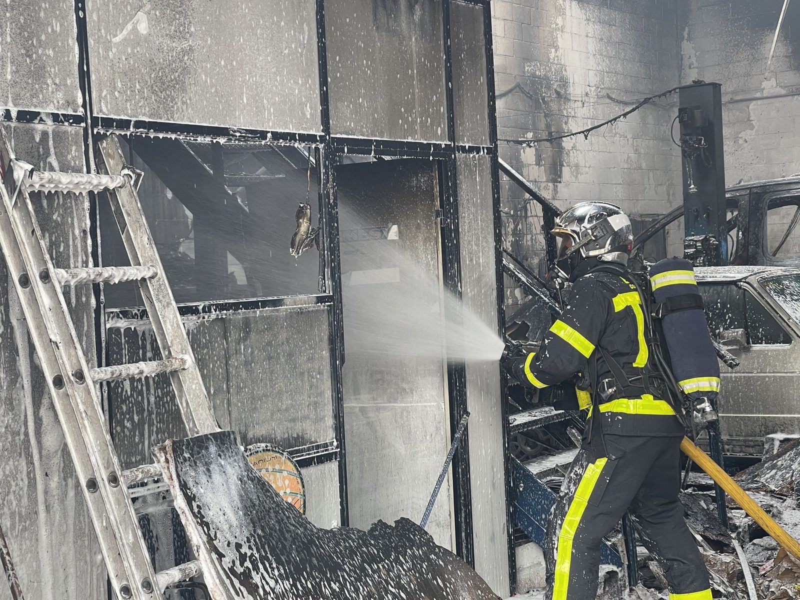 Un bombero de la Comunidad de Madrid ataca el fuego dentro de la instalación